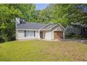 Charming single-story home with vinyl siding, an attached garage, and a well-maintained front yard at 785 Redland Dr, Jonesboro, GA 30238