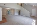 Open-concept living room features a fireplace, soaring ceilings, and plush carpet at 785 Redland Dr, Jonesboro, GA 30238