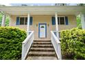 Charming front porch with brick stairs, white railings, and bright blue shutters, perfect for relaxing at 3003 Butler Creek Nw Rd, Kennesaw, GA 30152
