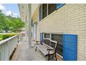 Relaxing front porch featuring an ornate bench, blue shutters, and a serene view at 3003 Butler Creek Nw Rd, Kennesaw, GA 30152