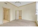 Neutral bedroom with closet and two doorways, featuring carpeted floors and natural light at 3445 Stratford Ne Rd # 305, Atlanta, GA 30326