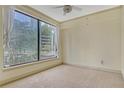 Cozy bedroom featuring neutral carpet, a ceiling fan, and a large window at 3445 Stratford Ne Rd # 305, Atlanta, GA 30326
