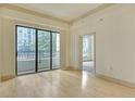 Bright living room with hardwood floors and large glass doors to the balcony at 3445 Stratford Ne Rd # 305, Atlanta, GA 30326