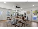 Inviting living room with hardwood floors, a ceiling fan, and an open layout to the kitchen at 3634 Oakleaf Pass, Fairburn, GA 30213