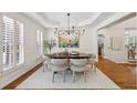 Bright dining room featuring wainscoting, hardwood floors, and natural light from large windows at 4058 Vinings Mill Se Trl, Smyrna, GA 30080