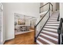 Inviting entryway with hardwood floors, staircase, and view into the formal dining room at 4058 Vinings Mill Se Trl, Smyrna, GA 30080
