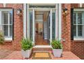Elegant front entryway featuring a brick porch and beautiful glass paneled doors at 4058 Vinings Mill Se Trl, Smyrna, GA 30080