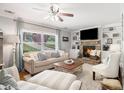 Cozy living room with a stone fireplace, built-in bookshelves, and large windows for natural light at 3013 Surrey Ln, Atlanta, GA 30341