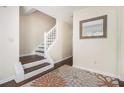 Staircase with dark wood steps and white risers complemented by a decorative rug at 4207 Fortune Pt, South Fulton, GA 30349