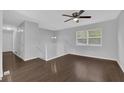 Bright living room featuring dark hardwood flooring and a large window at 4665 Big Valley Rd, Stone Mountain, GA 30083
