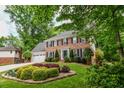 Charming brick home with a well-manicured lawn and landscape at 615 Woodwork Way, Roswell, GA 30076