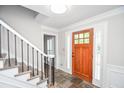 Elegant foyer features a stylish wooden door, slate floors, and staircase at 615 Woodwork Way, Roswell, GA 30076