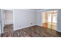 Spacious living room with hardwood-style floors and doorways to other rooms at 615 Woodwork Way, Roswell, GA 30076