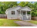 Inviting home with a cozy front porch, manicured lawn, and classic architecture amidst a serene neighborhood at 1596 Foote Ne St, Atlanta, GA 30307