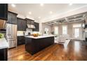Modern kitchen with dark cabinets, stainless steel appliances, and a bright white countertop island at 2119 Dee Dee Muse Nw Ln, Atlanta, GA 30318