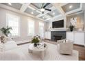 Bright living room with coffered ceiling, fireplace, white built-ins, and neutral furnishings at 2119 Dee Dee Muse Nw Ln, Atlanta, GA 30318