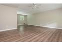 Spacious living area with hardwood floors flowing into the kitchen with updated fixtures and stainless steel appliances at 4855 Brownsville Rd, Powder Springs, GA 30127