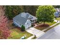 Aerial view of a lovely home, with a well-kept lawn and mature trees in the background at 570 Highcrest Dr, Acworth, GA 30101