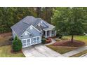 Aerial view of home with well-maintained lawn, mature trees, and two-car garage at 570 Highcrest Dr, Acworth, GA 30101