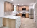 Modern kitchen with stainless steel appliances, quartz countertops, and stylish wooden cabinets at 2094 Shamrock Dr, Decatur, GA 30032