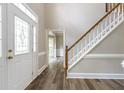 Bright foyer featuring wood-look floors, staircase, and leaded glass front door at 3761 Bays Ferry Way, Marietta, GA 30062