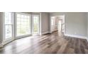 Sunlit living room showcasing wood-look floors and a bay window, great for entertaining at 3761 Bays Ferry Way, Marietta, GA 30062