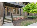 Brick townhome with front stoop and garden featuring seasonal plantings at 1032 Robert Smalls Way, Atlanta, GA 30318