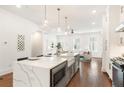 Well-lit kitchen featuring island seating, stainless appliances, and modern finishes at 1032 Robert Smalls Way, Atlanta, GA 30318