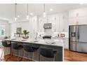 Modern kitchen with a waterfall island, pendant lights, and stainless steel refrigerator at 1032 Robert Smalls Way, Atlanta, GA 30318