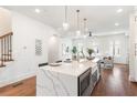 Contemporary kitchen with a quartz island, bar stools, and stainless steel microwave at 1032 Robert Smalls Way, Atlanta, GA 30318