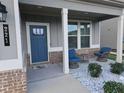 Inviting front porch featuring chairs and a table, creating a welcoming outdoor space at 221 Eleanora Way, Loganville, GA 30052