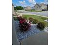 Landscaped front yard featuring colorful shrubs surrounded by white decorative rocks at 221 Eleanora Way, Loganville, GA 30052