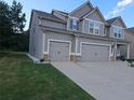 Attached garage for two vehicles providing ample space for parking and storage at 221 Eleanora Way, Loganville, GA 30052