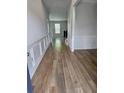Inviting hallway featuring wood-look flooring and decorative wainscoting on the walls at 221 Eleanora Way, Loganville, GA 30052
