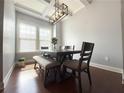 Bright dining room with large windows, modern light fixture, and seating for six at 4487 Kerrington Ave, Sugar Hill, GA 30518