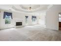 Bright living room with fireplace, trey ceiling, elegant chandelier, and large windows at 538 First St, Lawrenceville, GA 30046