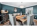 Dining room featuring wainscotting, a wine rack and large wooden table at 2349 June Springs Sw Dr, Marietta, GA 30008