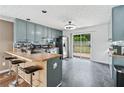 A kitchen with grey cabinets, stainless steel appliances and a sliding glass door to the backyard at 2349 June Springs Sw Dr, Marietta, GA 30008