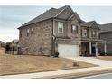 Two-story home with a two-car garage, brick and siding exterior, and manicured front lawn at 3566 Andover Way, Buford, GA 30519