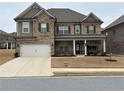 Charming two-story home with brick and stone accents, covered porch, and well-maintained landscaping at 3566 Andover Way, Buford, GA 30519
