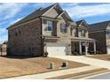 Beautiful two-story home featuring brick and siding, a well-manicured lawn, and an attached two-car garage at 3566 Andover Way, Buford, GA 30519