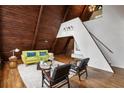 Stylish living room showcasing a unique wood ceiling, large windows, modern furniture, and a cozy white rug at 3567 Beachhill Dr, Atlanta, GA 30340