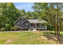 Charming single-story home with gray siding, a covered front porch, and attractive landscaping at 588 Peachtree Se Dr, White, GA 30184