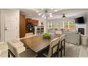 Bright dining room with modern light fixture, hardwood floors and access to living room at 690 Cobblestone Creek Ln, Mableton, GA 30126
