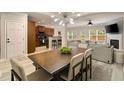 Open concept dining room offering fireplace, tv, and abundant natural light at 690 Cobblestone Creek Ln, Mableton, GA 30126