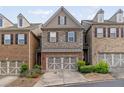 Exterior of a home featuring stone accents, brick accents, and an attached garage at 690 Cobblestone Creek Ln, Mableton, GA 30126