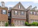 Exterior of a charming home featuring stone and brick accents, plus an attached garage at 690 Cobblestone Creek Ln, Mableton, GA 30126