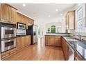 Well-equipped kitchen with stainless steel appliances, granite countertops, and warm wood cabinets at 1545 Center Cross Pass, Marietta, GA 30062
