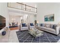 Bright living room featuring high ceilings, plush seating, and modern decor, with a view of the dining area at 1545 Center Cross Pass, Marietta, GA 30062