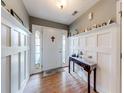 Inviting foyer featuring stylish wainscoting, hardwood floors, and decorative shelving at 1720 Alcovy River Dr, Dacula, GA 30019